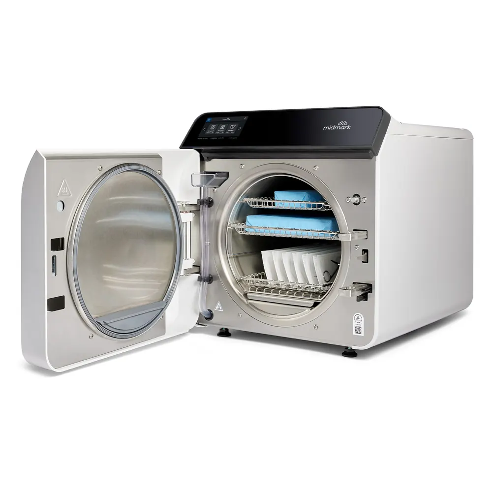Open Midmark tabletop autoclave with sterilization trays ready for rental