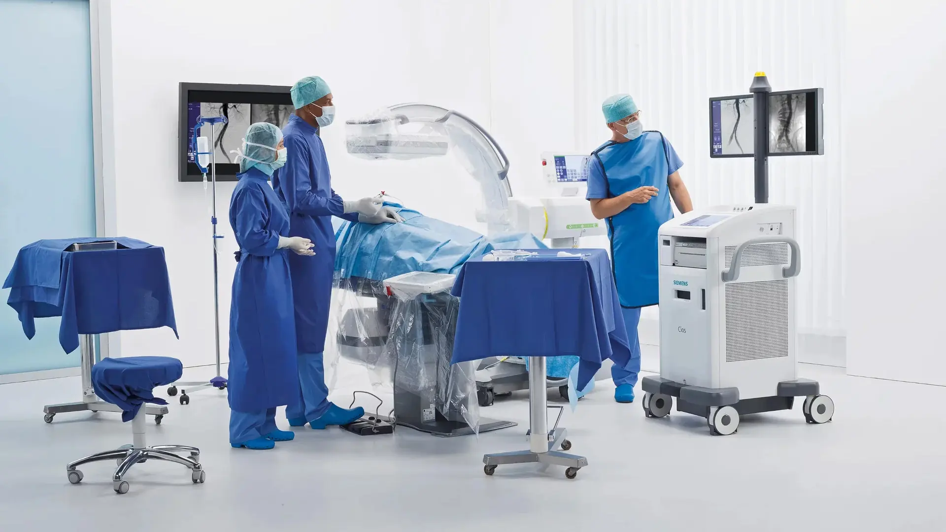 Surgical team using a mobile C-arm imaging system in an operating room