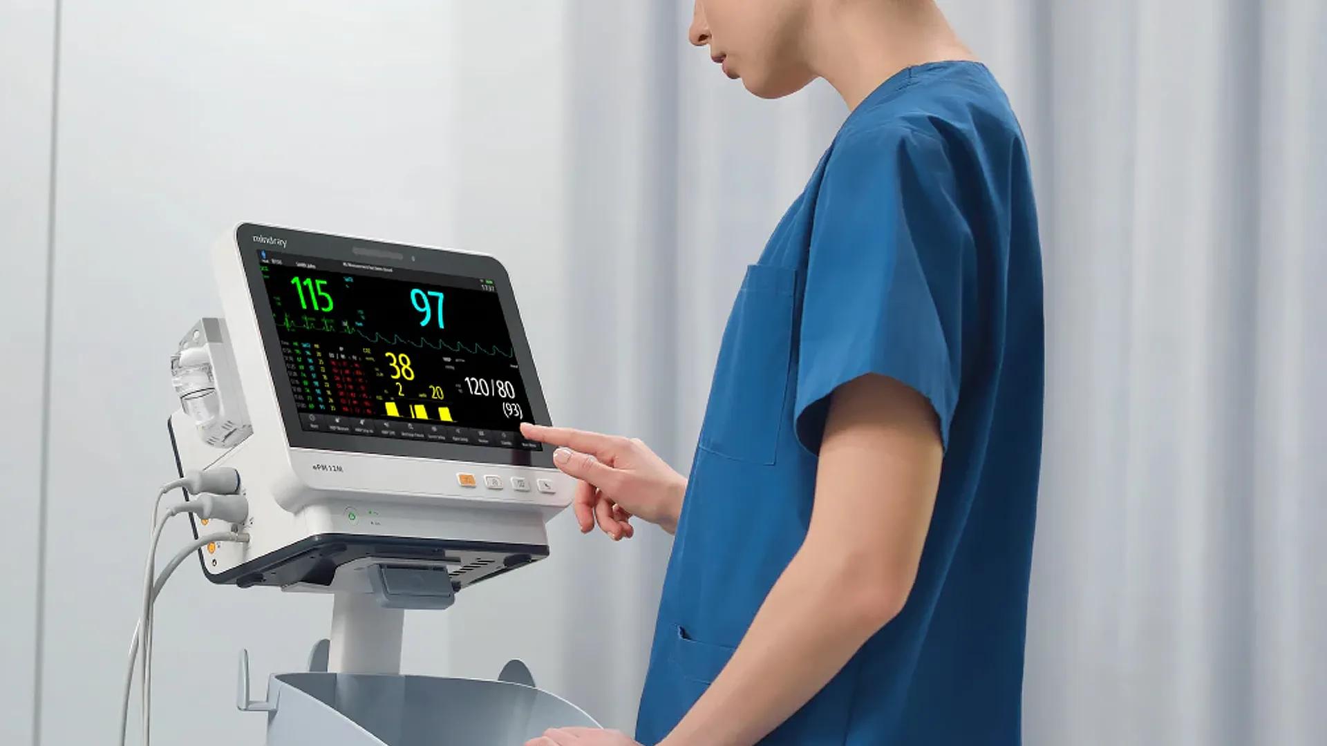 Clinician using a patient monitor on a medical cart