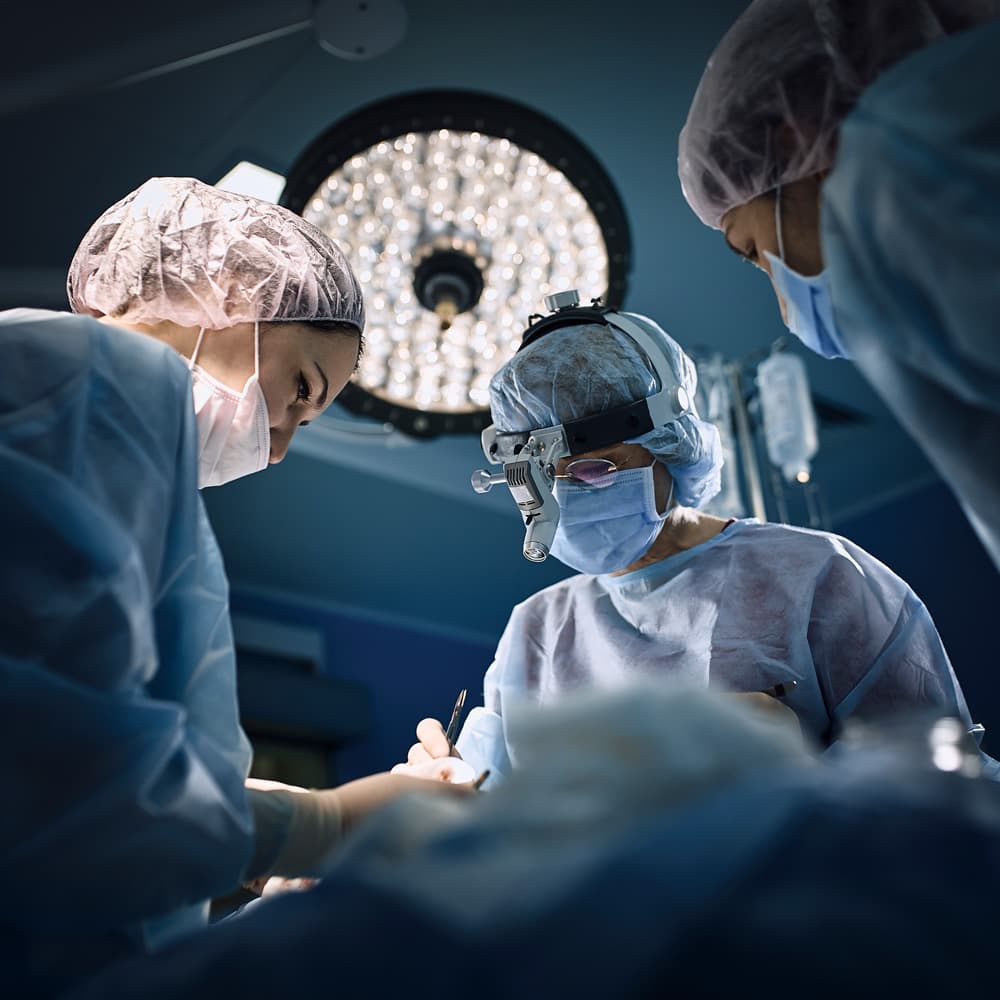 Surgical team working under operating room lights during a procedure